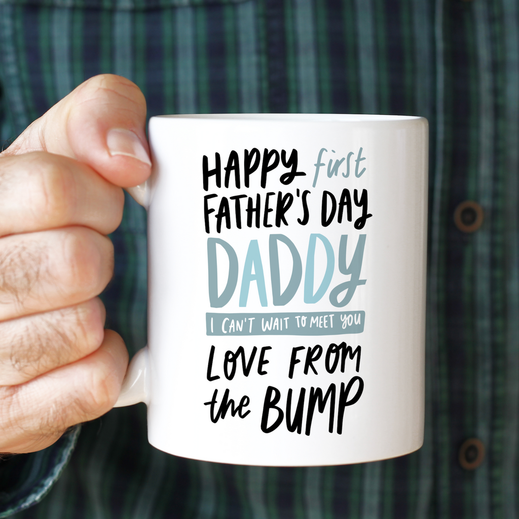An 11oz ceramic mug reading "Happy First Father's Day Daddy I Can't Wait To Meet You Love From the Bump" father's day mug