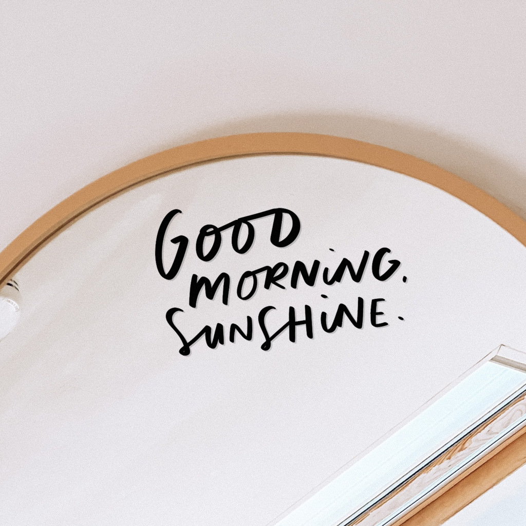 Hand-lettered vinyl positive mirror decal reading "Good Morning Sunshine"