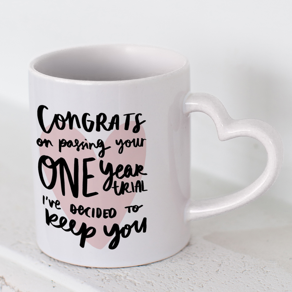 11oz ceramic mug with a heart shaped handle reading "Congrats On Passing Your One Year Trial I've Decided To Keep You" first anniversary gift