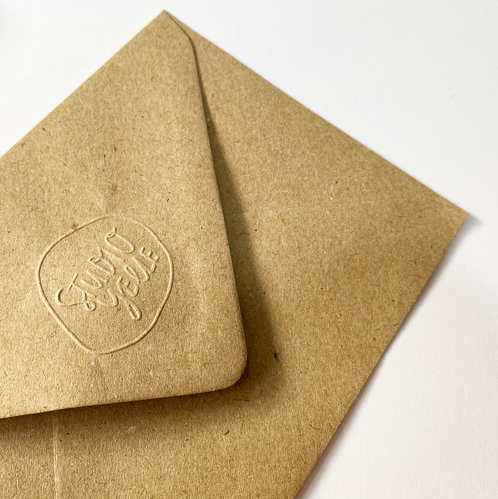 Kraft envelope embossed with the Studio Yelle logo