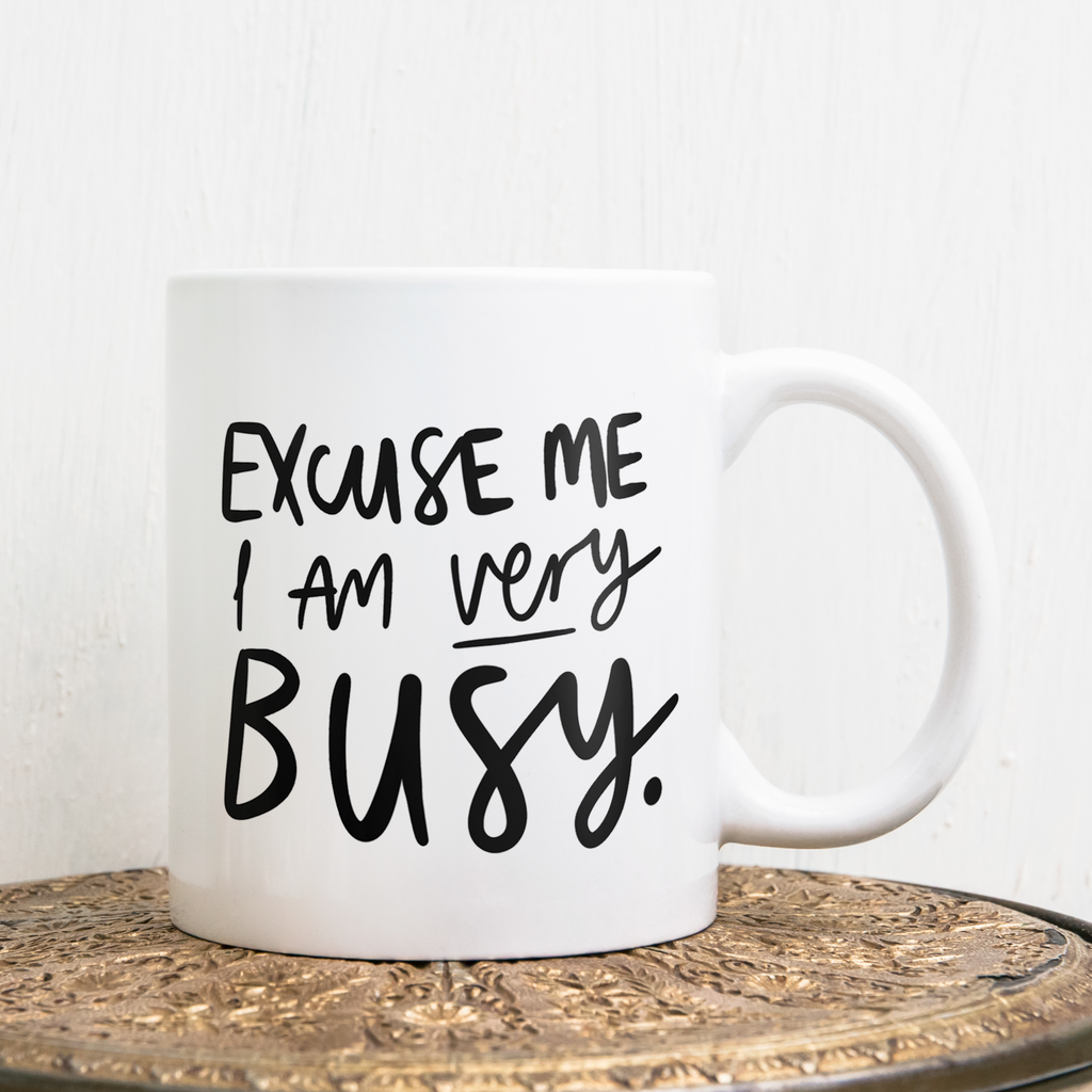 An 11oz ceramic mug reading "Excuse Me I Am Very Busy"