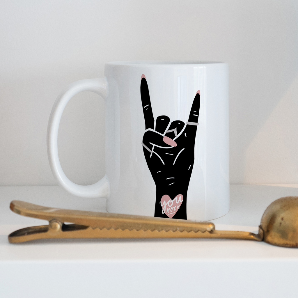 An 11oz ceramic mug featuring a tattooed hand saying "You Rock" gift for friend